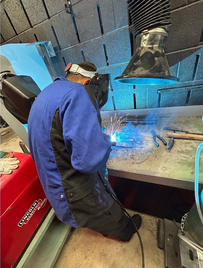 Student Isaac Bueno practices overlapping welds on a 12 inch pad. Students in the district's welding program learn about safety protocols and how to use the equipment, while also working toward a possible career choice.